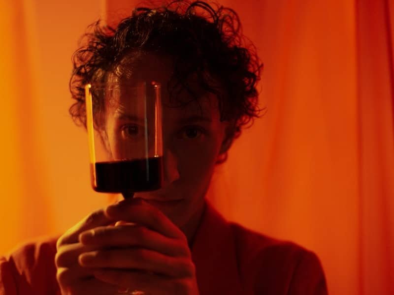 Man with glass of wine; is alcohol affecting your mental health?