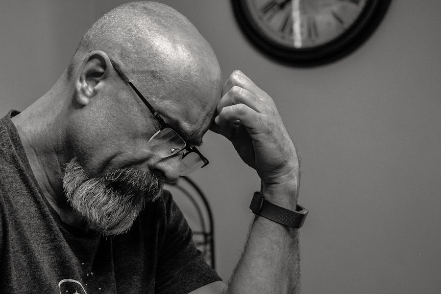 Sad bald man, illustrating men's mental health issues.